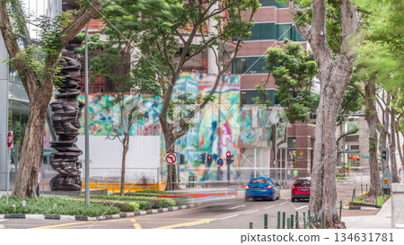Battery Road avenue with traffic and surrounded by green trees in downtown timelapse, Singapore Battery Road avenue with traffic and surrounded by green trees in downtown timelapse, Singapore 134631781