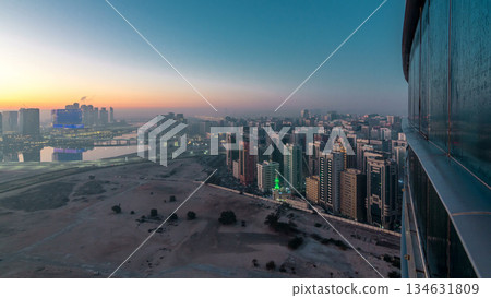 Abu Dhabi city skyline with skyscrapers before sunrise from above night to day timelapse 134631809
