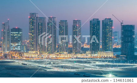 Buildings on Al Reem island in Abu Dhabi day to night timelapse from above. Buildings on Al Reem island in Abu Dhabi day to night timelapse from above. 134631861