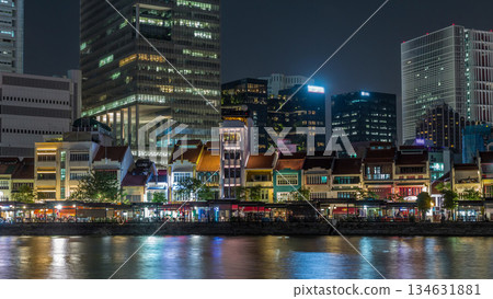 Singapore quay with tall skyscrapers in the central business district on Boat Quay night timelapse hyperlapse 134631881