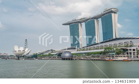 Fifty-five storeys high Marina Bay Sands Hotel dominates the skyline at Marina Bay in Singapore timelapse hyperlapse. 134631909