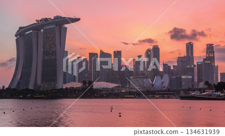 Downtown skyline of Singapore as viewed from across the water from The Garden East day to night timelapse. Singapore. Downtown skyline of Singapore as viewed from across the water from The Garden East day to night timelapse. Singapore. 134631939