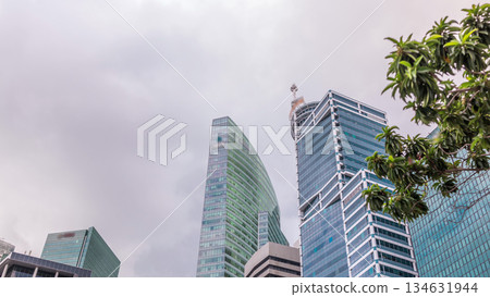 Looking up perspective of modern business skyscrapers glass and sky view landscape of commercial building in central city timelapse 134631944