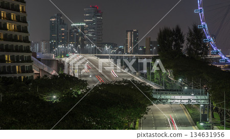Traffic with cars on a street and urban scene in the central district of Singapore night timelapse Traffic with cars on a street and urban scene in the central district of Singapore night timelapse 134631956