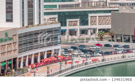 Parking near canal in Dubai at sunny day, UAE aerial timelapse Parking near canal in Dubai at sunny day, UAE aerial timelapse 134631968