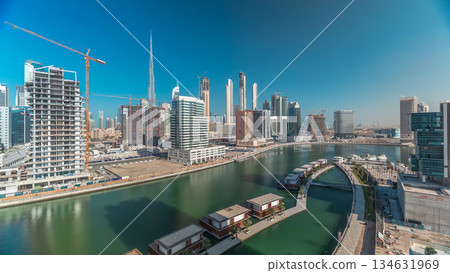 Skyscrapers near canal in Dubai with blue sky aerial timelapse 134631969
