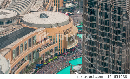 Lots of tourists walking near fountains and shopping mall in Dubai downtown night timelapse 134631988