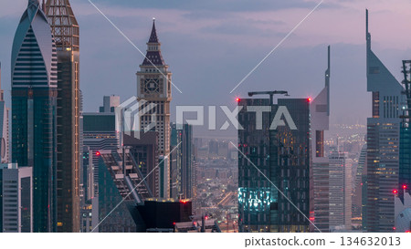 Dubai International Financial Centre district with modern skyscrapers night to day timelapse Dubai International Financial Centre district with modern skyscrapers night to day timelapse 134632013