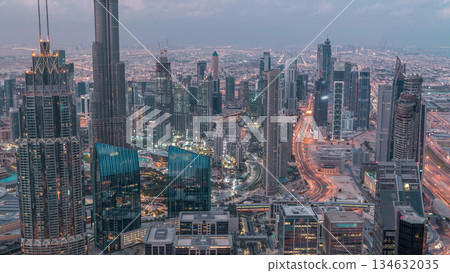 Dubai Downtown skyline futuristic cityscape with many skyscrapers and Burj Khalifa aerial night to day timelapse. Dubai Downtown skyline futuristic cityscape with many skyscrapers and Burj Khalifa aerial night to day timelapse. 134632035