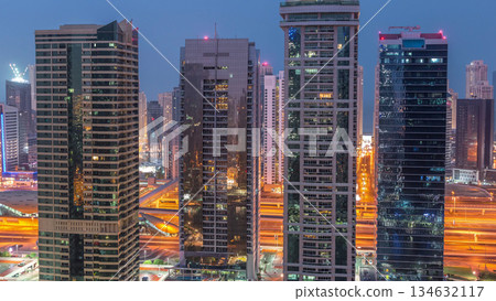 Residential and office buildings in Jumeirah lake towers district night to day timelapse in Dubai Residential and office buildings in Jumeirah lake towers district night to day timelapse in Dubai 134632117