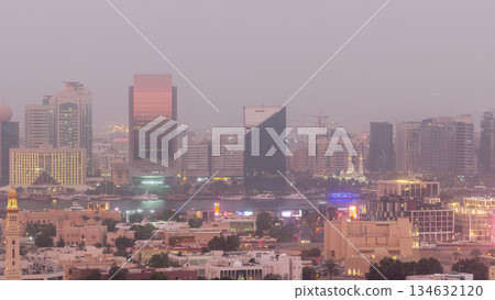 Deira modern and old buildings canal aerial view of Dubai Creek day to night timelapse. Deira modern and old buildings canal aerial view of Dubai Creek day to night timelapse. 134632120