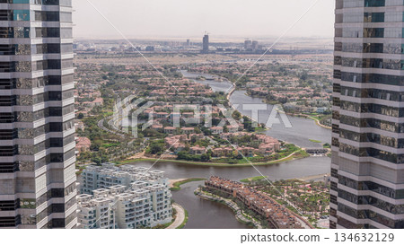Aerial view of apartment houses and villas in Dubai city timelapse, United Arab Emirates Aerial view of apartment houses and villas in Dubai city timelapse, United Arab Emirates 134632129