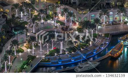 Dubai Marina Walk with fountain and palms aerial Top View night timelapse 134632139