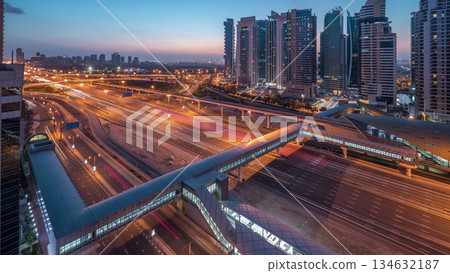 Aerial top view to Sheikh Zayed road near Dubai Marina and JLT night to day timelapse, Dubai. Aerial top view to Sheikh Zayed road near Dubai Marina and JLT night to day timelapse, Dubai. 134632187