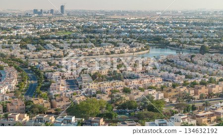Aerial view to villas and houses with Golf course with green lawn and lakes timelapse 134632192