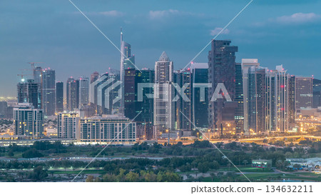 Jumeirah lake towers skyscrapers and golf course night to day timelapse, Dubai, United Arab Emirates Jumeirah lake towers skyscrapers and golf course night to day timelapse, Dubai, United Arab Emirates 134632211