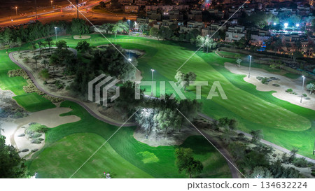 Aerial view to Golf course and villas with houses night timelapse Aerial view to Golf course and villas with houses night timelapse 134632224