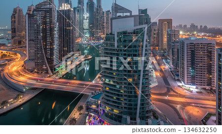 Aerial view of Dubai Marina residential and office skyscrapers with waterfront night to day timelapse 134632250