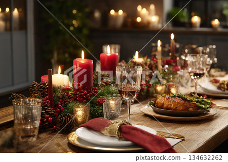 Elegant Christmas Dinner Table with Candlelight, Festive Tableware, and Cozy Holiday Dining Atmosphere 134632262