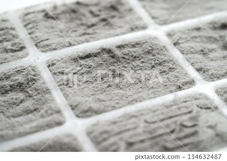 Dust covered filter surface with fiber structure and grid pattern. Air pollution buildup. Clogged filtration material 134632487