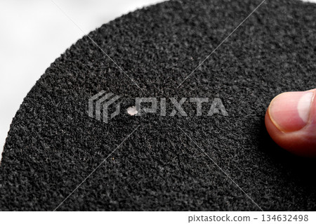 Hand holding water purification filter with fibrous texture and black rough surface Hand holding water purification filter with fibrous texture and black rough surface 134632498