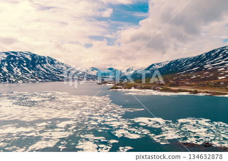Rocky landscape. View of the melt lake Breiddalsvatnet in early summer from the Toller Aussicht viewpoint. Hamsevika, Grotli, Norway Rocky landscape. View of the melt lake Breiddalsvatnet in early summer from the Toller Aussicht viewpoint. Hamsevika, Grotli, Norway 134632878