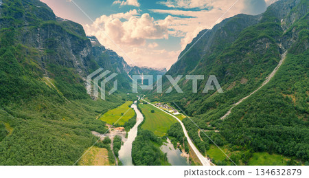 Aerial view of mountain valley with river and road. Naeroydalen Valley, Gudvangen, Norway Aerial view of mountain valley with river and road. Naeroydalen Valley, Gudvangen, Norway 134632879