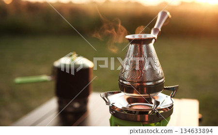 Cezve Heating Water On A Portable Gas Stove Cezve Heating Water On A Portable Gas Stove 134633894