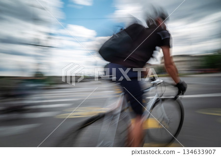 Rushing Sport Bicyclist With Motion Effect On A City Street Rushing Sport Bicyclist With Motion Effect On A City Street 134633907