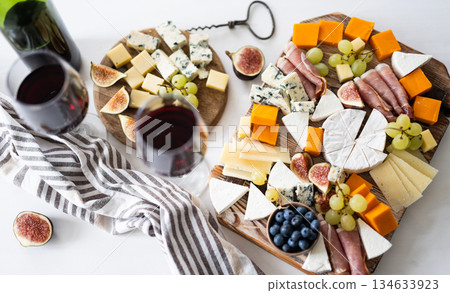 Delicious Cheese Board With Cheese, Wine And Fruits Delicious Cheese Board With Cheese, Wine And Fruits 134633923