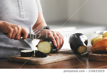 Girl Cutting Eggplant On A Cutting Board For Girl Cutting Eggplant On A Cutting Board For 134633929