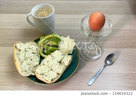 Healthy and Delicious Breakfast Spread with Coffee, Egg, Avocado, and Herb Bread 134634322