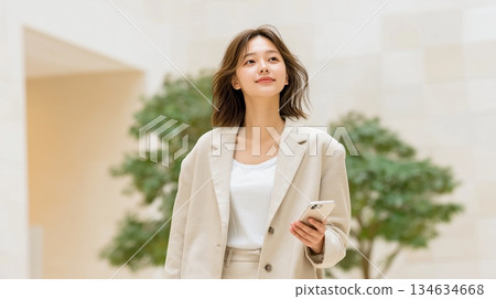 A young businesswoman heading on a business trip with her smartphone 134634668