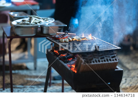 Grilling fresh fish and chorizo on a hot barbecue Grilling fresh fish and chorizo on a hot barbecue 134634718