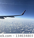 A view of the sea, land and sky seen from the window of an airplane 134634803