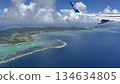 A view of the sea, land and sky seen from the window of an airplane 134634805
