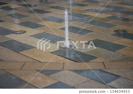 Water Fountain Jet on Tiled Ground 134634953