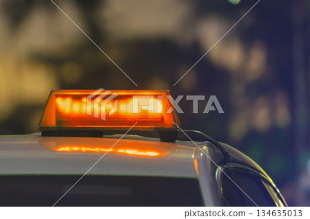 Taxi checkers on the roof of a taxi car at sunset close-up. A glowing red yellow taxi sign on the car. High quality photo Taxi checkers on the roof of a taxi car at sunset close-up. A glowing red yellow taxi sign on the car. High quality photo 134635013