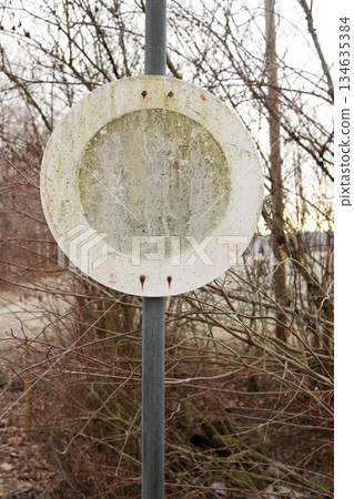 Old Weathered Blank Round Road Sign in Nature 134635384