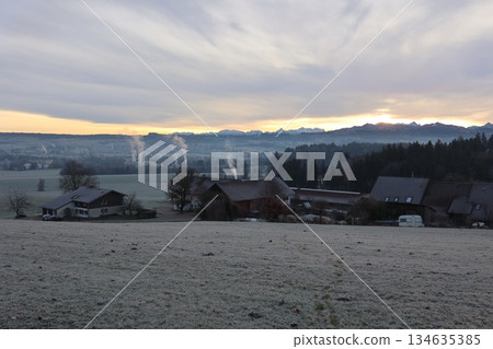 Frosted Rural Landscape with Mountain Range at Sunrise Frosted Rural Landscape with Mountain Range at Sunrise 134635385
