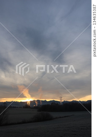 Industrial Smoke Stacks at Sunset Over Mountains Industrial Smoke Stacks at Sunset Over Mountains 134635387