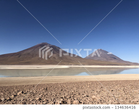 A beautiful summer volcano and snow-capped mountains on a clear midsummer morning against a clear blue sky 134636416