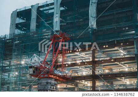 A construction site with the lights on at dusk 134638762