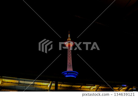 Low angle view of Kyoto Tower at night, Kyoto, Japan. Travel concept. Kyoto tower is the tallest building and a major tourist attraction in Kansai region in Japan. 134639121