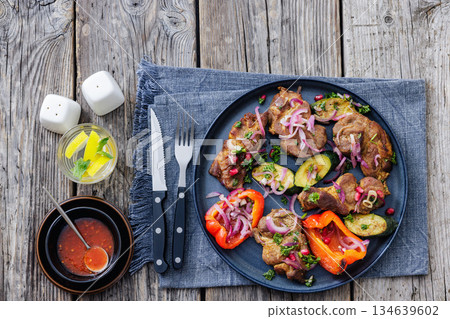 Grilled pork neck chunks with roasted veggies Grilled pork neck chunks with roasted veggies 134639602