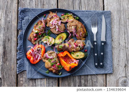 Grilled pork neck chunks with roasted veggies 134639604