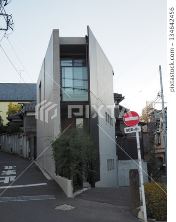A modern designer home built on a narrow urban lot, featuring original exposed concrete architecture 134642456