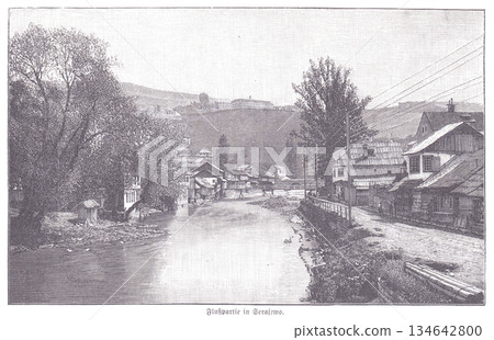 Historic Riverfront Village Scene in Sarajevo With Riverbank Homes and Hilltop Landscape 134642800