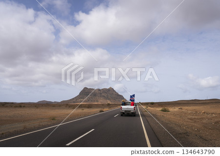 Off-road 4x4 tourist car with Cape Verde flag run in the desert road Off-road 4x4 tourist car with Cape Verde flag run in the desert road 134643790