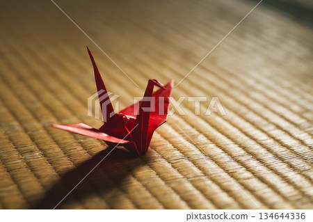 Red paper crane on tatami mat Red paper crane on tatami mat 134644336